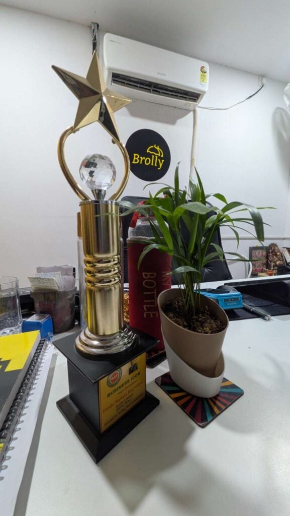Digital brolly photos of business achievement trophy displayed at Brolly office workspace